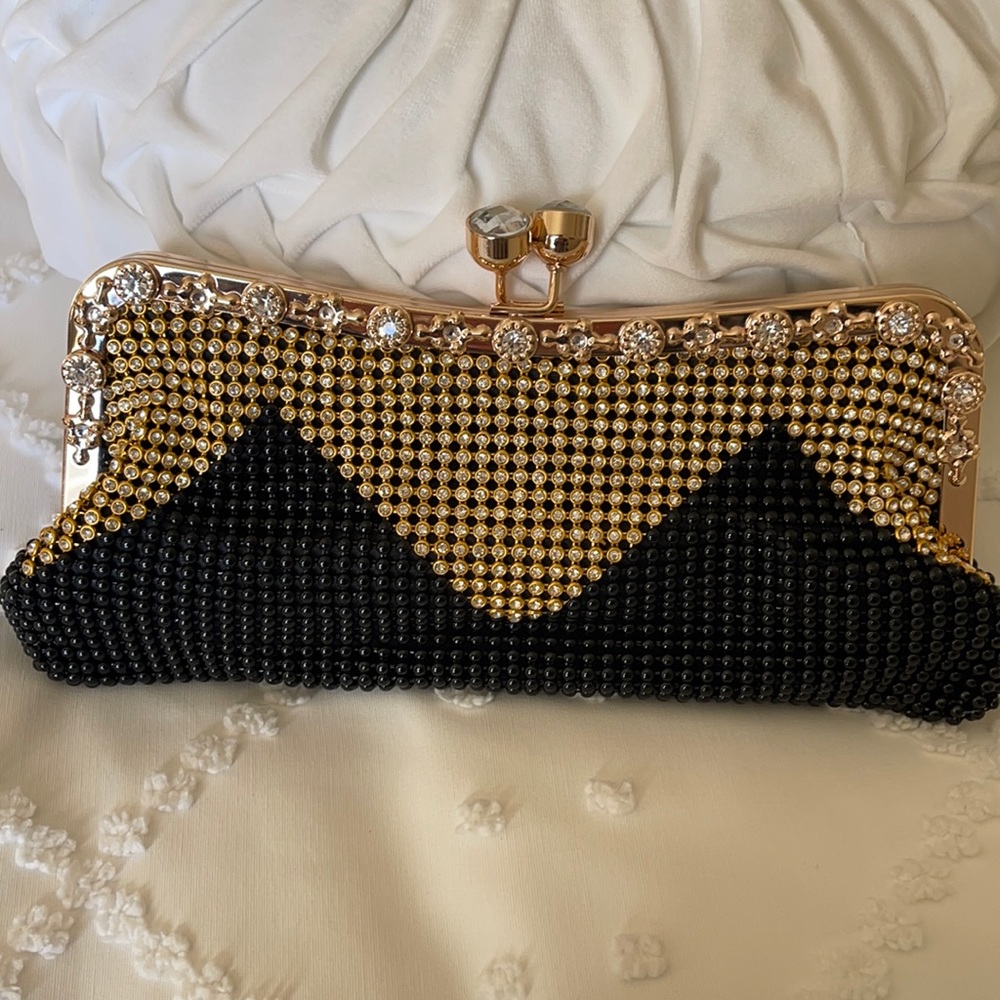 Party clutch decorated with gold and black beads